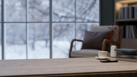 A close-up of a space for displaying products on a wooden coffee table in a cozy contemporary living room during winter, with a large window showcasing a snowy view outside. 3d render, 3d illustrationの写真素材