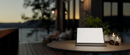 A digital tablet with a white screen mockup and a wireless keyboard on a table on a home balcony with a nature view at dusk. 3d render, 3d illustrationの写真素材