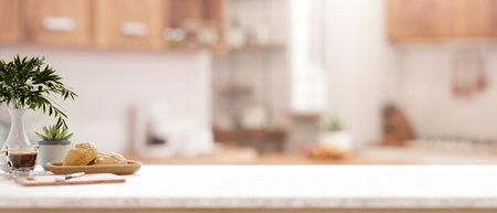 A kitchen tabletop or countertop with decorative items and a copy space for displaying products with a blurred background of a minimalist kitchen. 3d render, 3d illustrationの写真素材