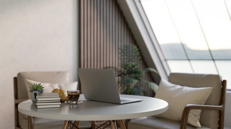 Laptop with coffee and breads aside books on white round table with armchair in living room or cafe....