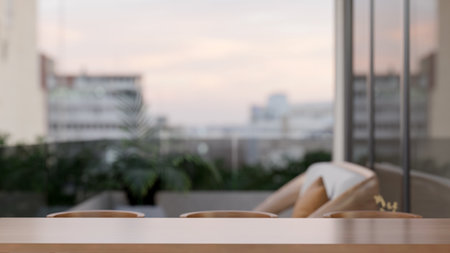 Empty wooden counter and chairs on house or building's terrace or balcony with glass railing...