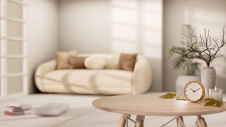 Clock and candle aside vase on round wooden table across sofa in a living room with bright sunlight....