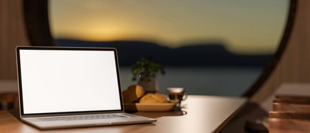White screen laptop and coffee and bread on wood table and morning sky over round window in dim room. Advertise Mockup, 3D Rendering, 3D illustration.の写真素材