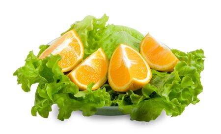 frash and green leaves of lettuce and halfs of orange. Isolated over whiteの写真素材