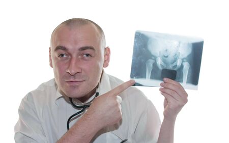 Young male doctor throwing a look to a chest x-ray image 