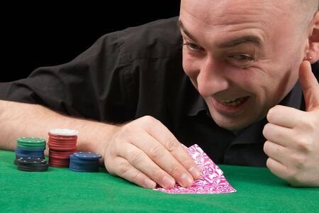 Poker gambler in black shirt close-up. Focus on the hand and eye のeditorial素材