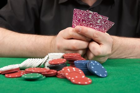 Poker gambler in black shirt close-up. Focus on the handsのeditorial素材
