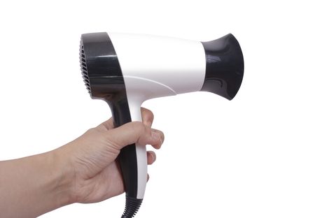 white and black Hair Dryer in a hand. Isolate over whiteの写真素材