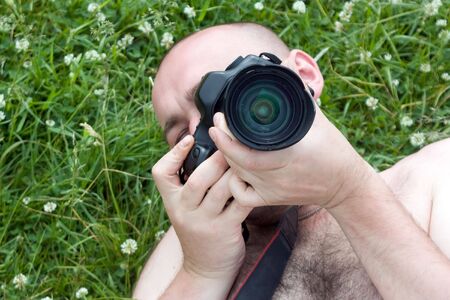 camera boy relax over green meadow in summerの写真素材
