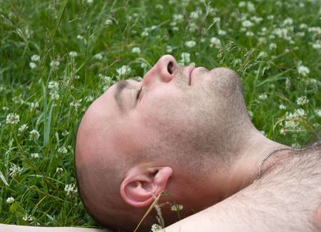 Fum man rest on green grass during summer dayの写真素材