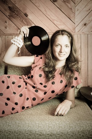  posing girl at vintage room with vinyl plateの写真素材
