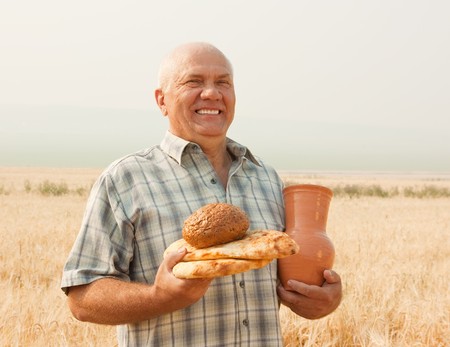 successful agriculturist with differents  baking foods and  jugの写真素材