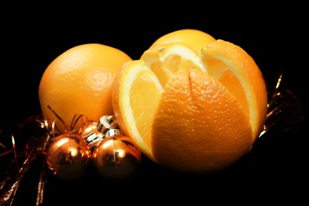 Three new year oranges over gold Christmas ballsの写真素材