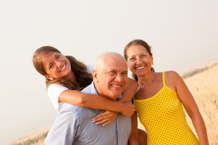 Senior father and mother whith teen daughter outdoor の写真素材