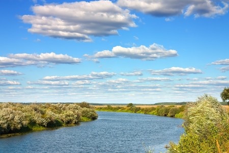 View of summer river under cloudy sky