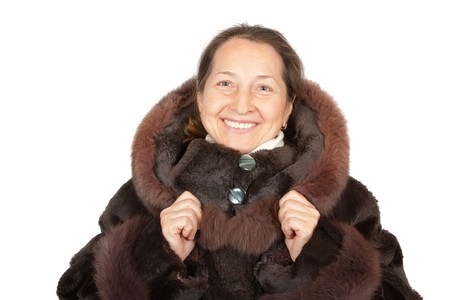   mature woman wearing a winter coat with fur の写真素材