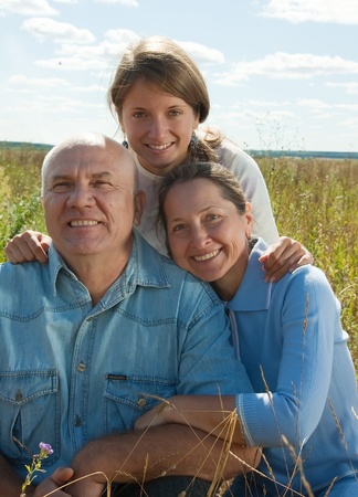 Beautiful cheerful family  go for a walk over a field の写真素材