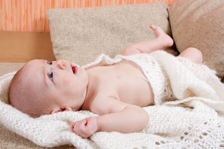 Pretty four month baby girl lying on a blanketの写真素材