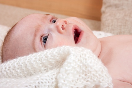 Pretty four month baby girl lying on a blanket