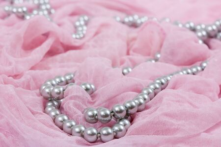 jewels on pink satin as a backgroundの写真素材