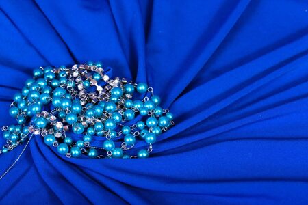 jewels on blue fabric as a backgroundの写真素材
