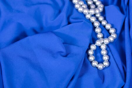 jewels on blue fabric as a backgroundの写真素材