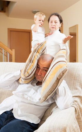 Family quarrel. Grandmom having problems with her son at homeの写真素材