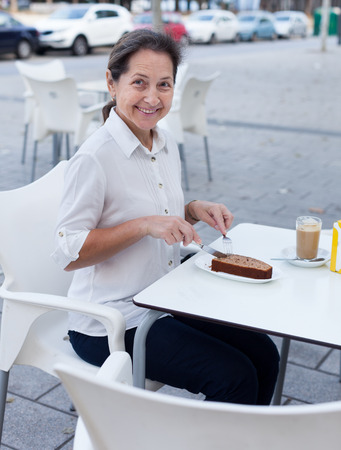 Portrait of  cute mature woman at coffee shop.の写真素材
