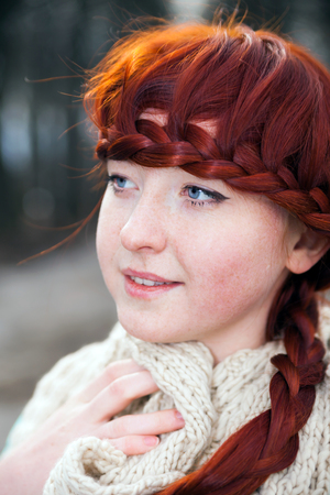 Portrait of   girl with red hair on   street.の写真素材