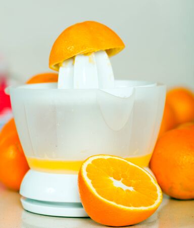 Preparation of orange juice with   hand juicer.