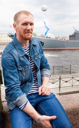 Portrait of   man with  beard in  sailor suit on ship background.