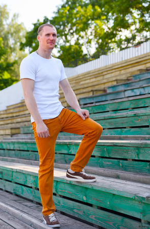 Cute   man standing  on vintage stadium.の写真素材