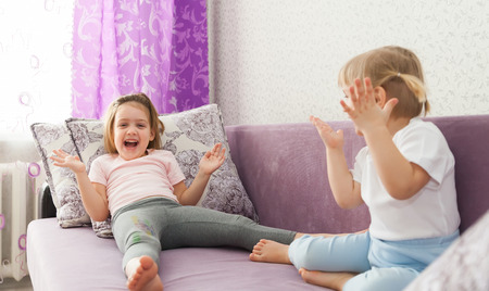 Little girl resting on   couch   home.の写真素材