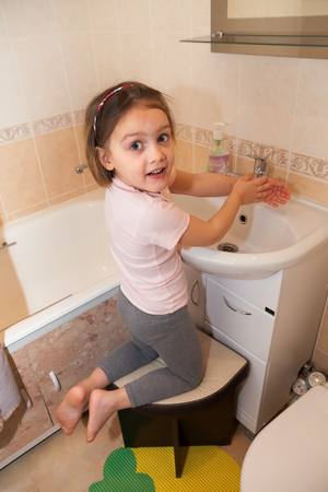 Girl washing hands with soap.の写真素材