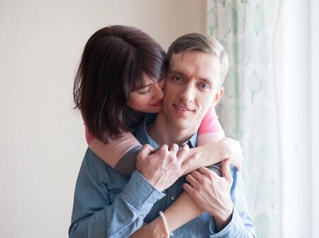 Beautiful couple   embracing   at home.
