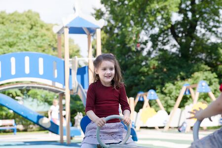 Girl of five years old riding on   swingの写真素材