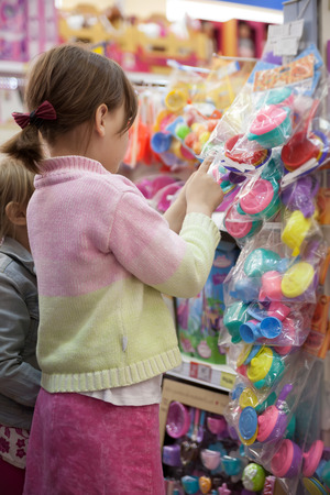 Two girlfriends choosing   gift in   toy storeの写真素材