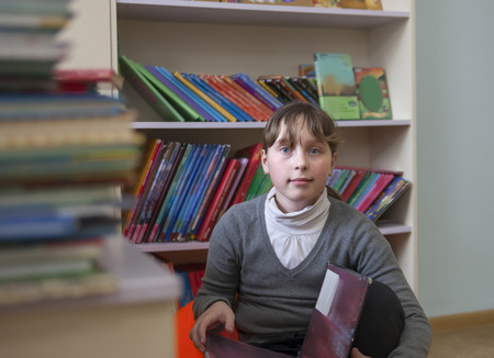  school girl reading   book in     library. 