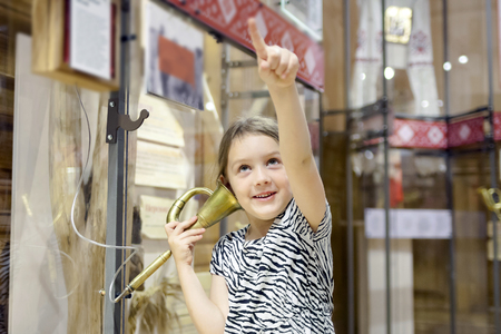   girl in   museum listening to interesting information about   exhibit through headphones.  の写真素材
