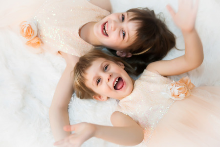 Two beautiful girls in festive dresses in  studio. の写真素材