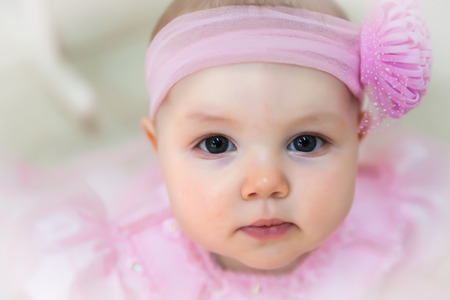 Portrait of   10-month-old girl in   festive dress in   studio.の写真素材