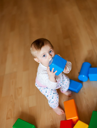 Baby with multi-colored designer at home on   floorの写真素材