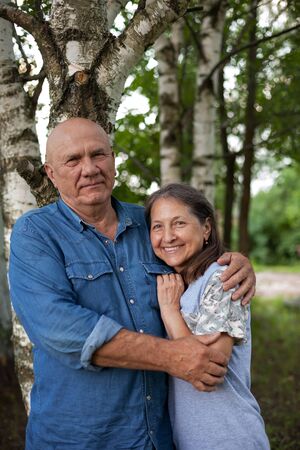 Mature couple in summer birch grove
