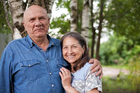Portrait of cute older man and woman in birch grove