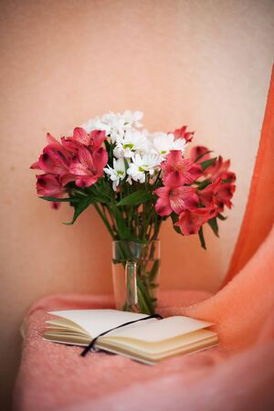 Beautiful chrysanthemum and Alstroemeria flowers in  transparent vaseの写真素材