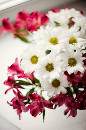 Beautiful chrysanthemum and Alstroemeria flowers in  transparent vaseの写真素材
