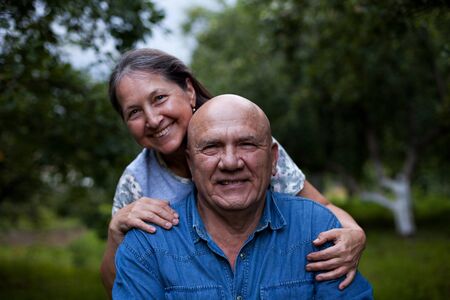 Portrait of   elderly couple   on   summer day.