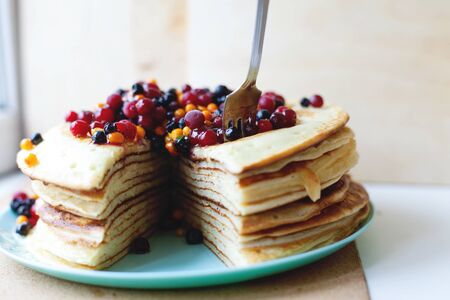 Hot delicious pancakes with different berries