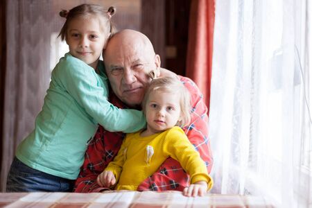 Portrait of grandparents with their granddaughters.の写真素材