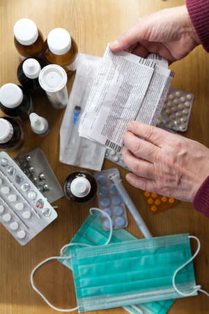 Hands of woman with summary of tablets in her hands